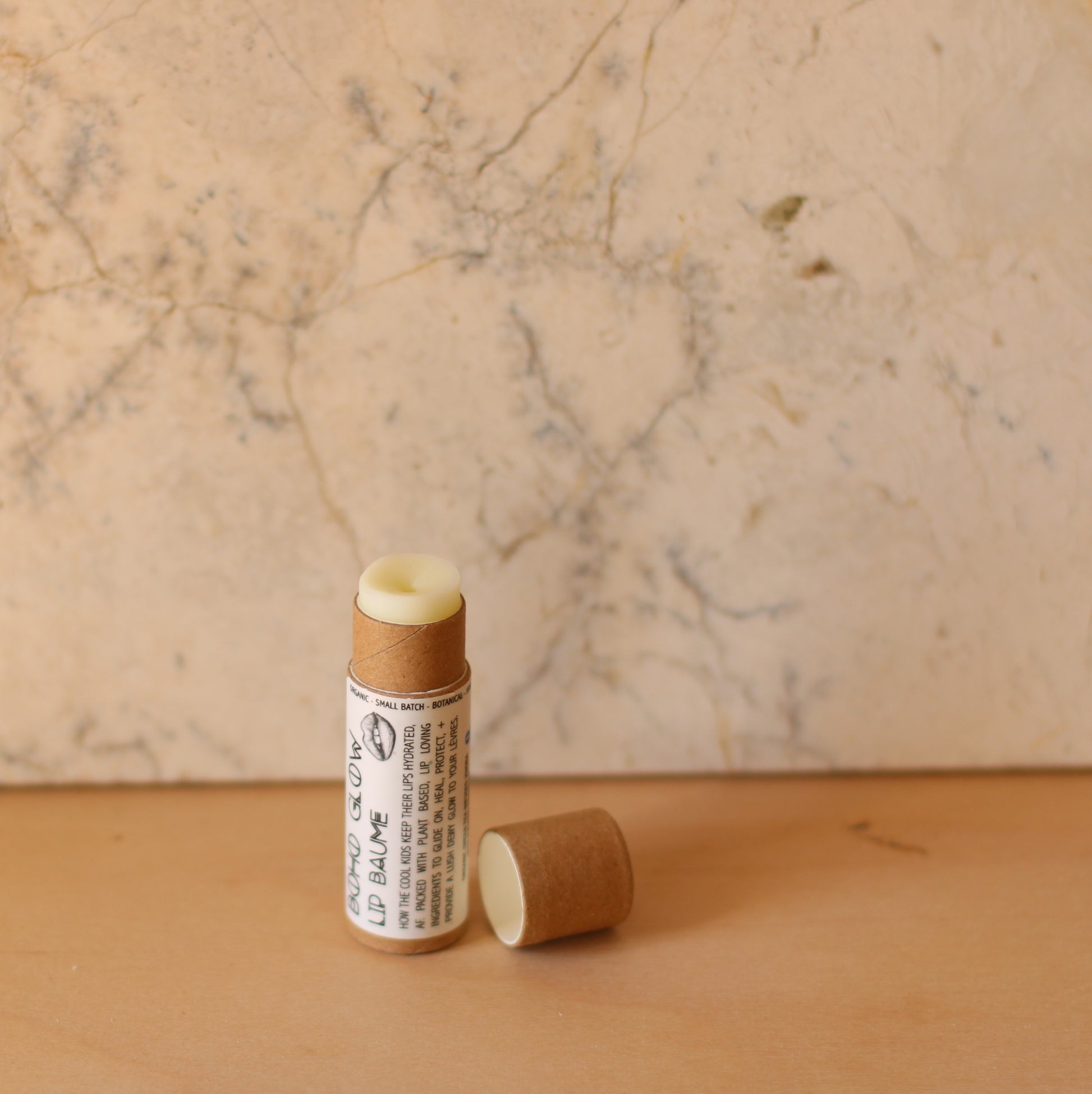 opened chapstick tube with marble wall background